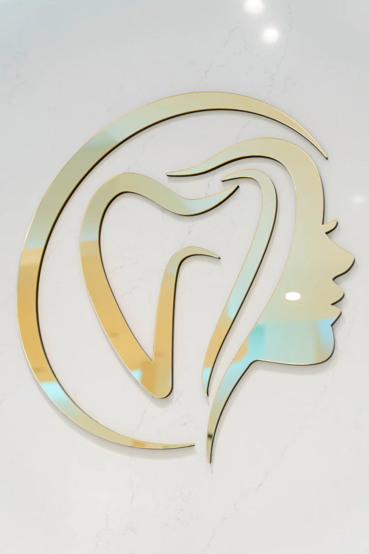 Upper Dental gold logo detail — facial aesthetics luxury care